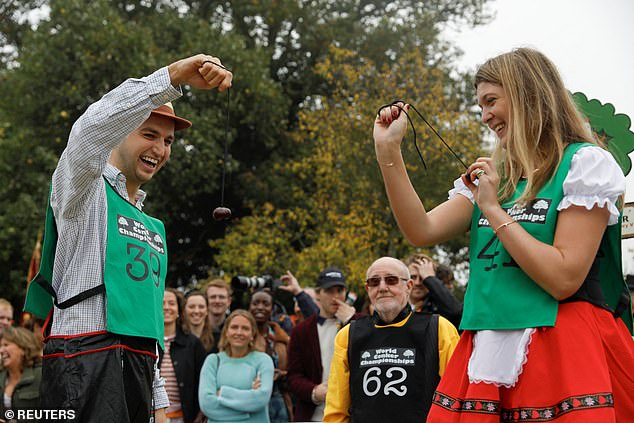 Two rivals do battle as participants try to demolish their opponent's conker by smashing it to smithereens