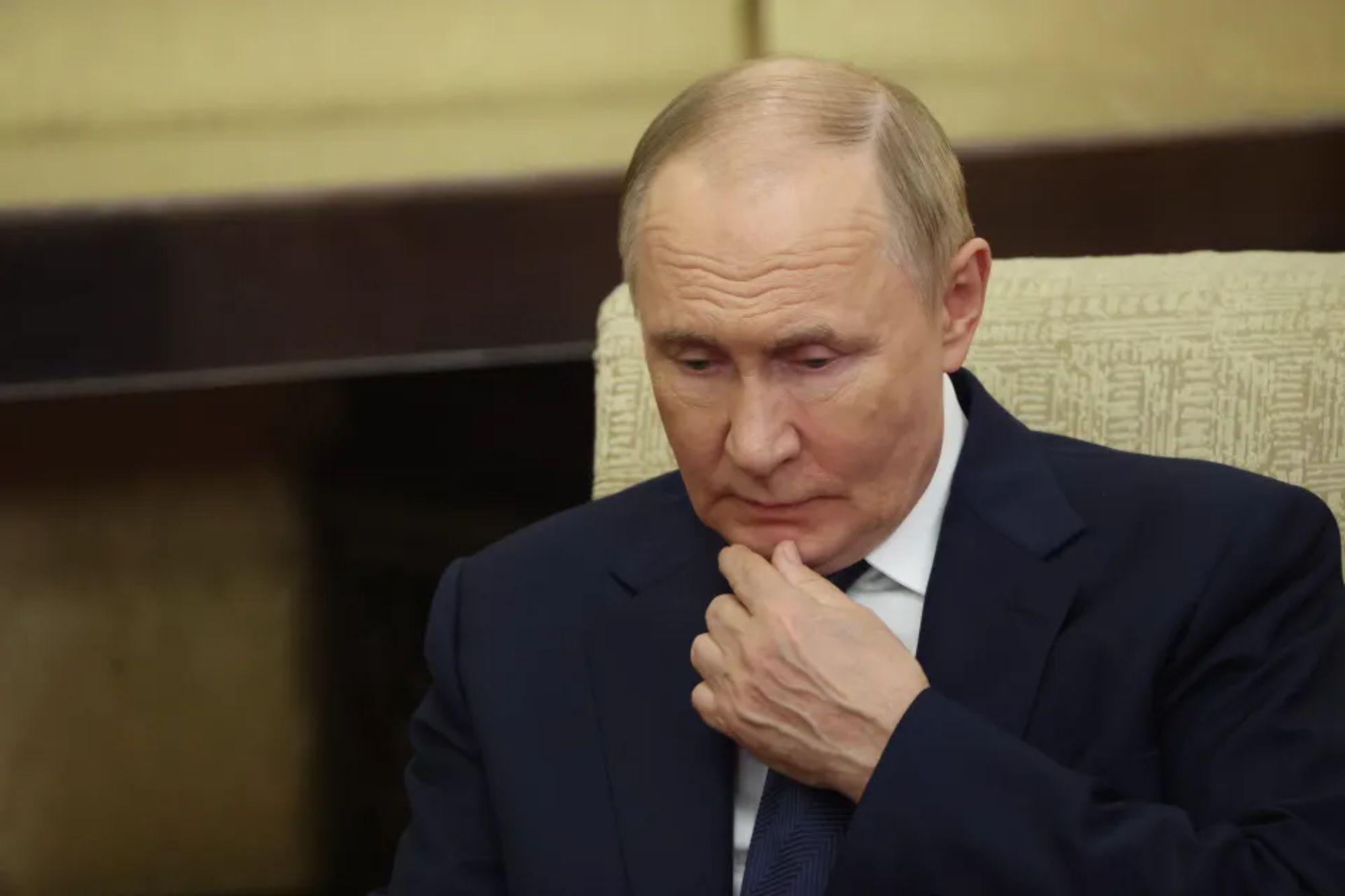 An image collage containing 1 images, Image 1 shows Russian President Putin in a dark suit, looking down with his hand on his chin