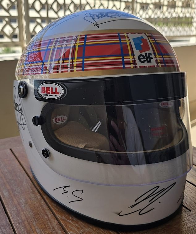 He signed MS on a white helmet with Royal Stewart Tartan, as worn by Jackie Stewart in his career, with the help of his wife Corinne