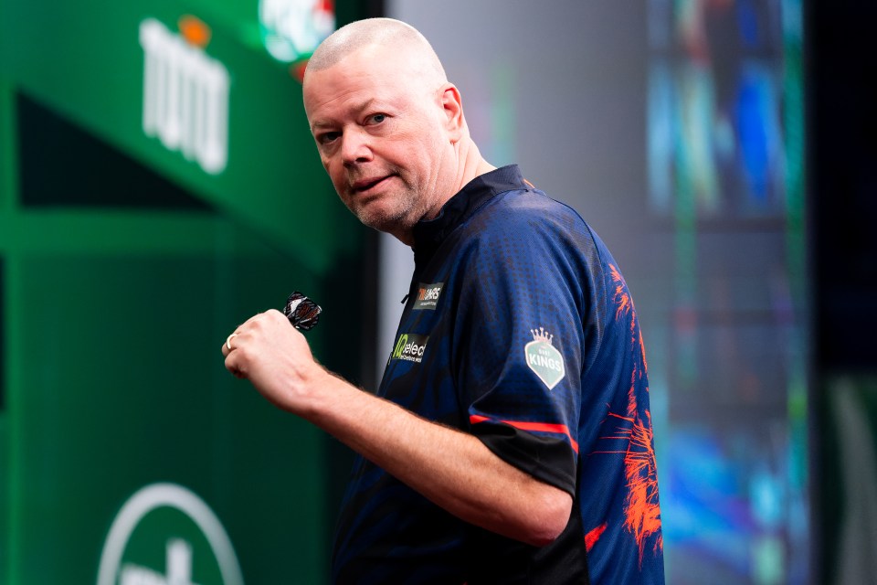 Raymond van Barneveld reacts during a darts match.