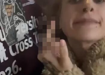 A pro-Palestinian supporter accused of 'pure visceral hatred' after she was filmed repeatedly spitting on a poster calling for the release of Israeli hostages has been revealed as an exotic dancer going by the name 'Scarlett Ankha'
