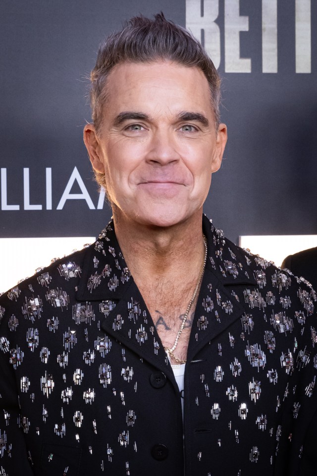 Robbie Williams smiling at the 'Better Man' premiere.