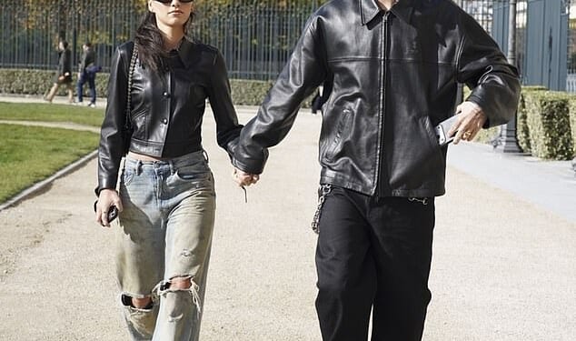 Romeo Beckham and Kim Turnbull held hands during a day out in Paris on Sunday confirming their relationship, six months after strain from his feud with brother Brooklyn led to split