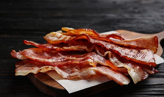 Experts warn that failure to ban nitrites from bacon and ham despite sounding alarm a decade ago has cost thousands of lives