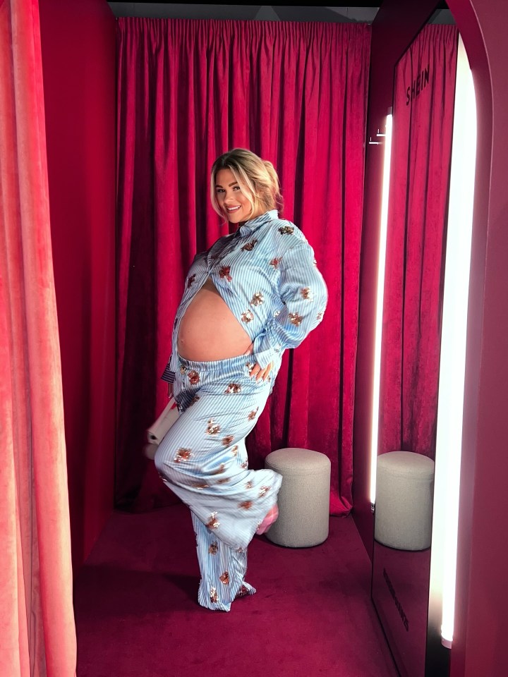 Shaughna Phillips pregnant, posing in pajamas with her baby bump exposed.