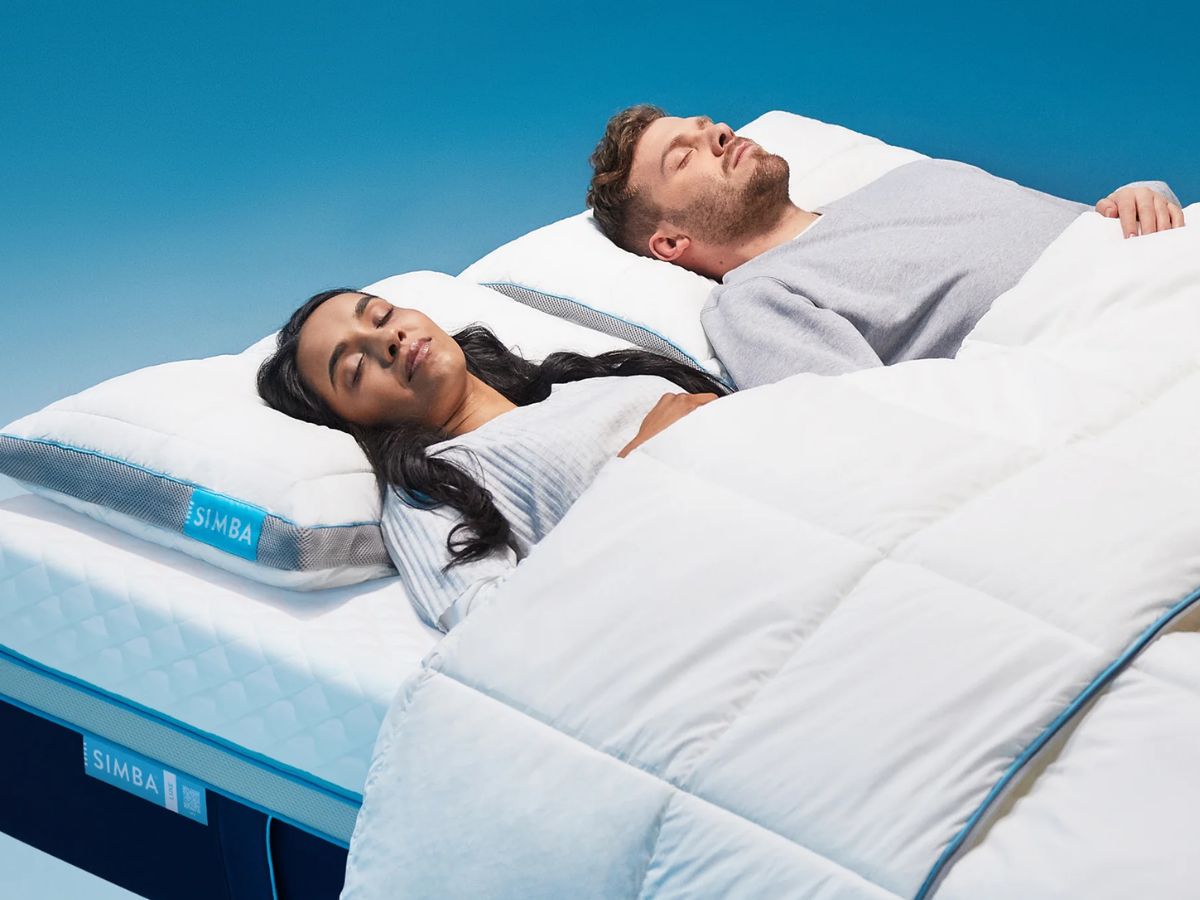 Two people sleeping peacefully on Simba mattresses and pillows.