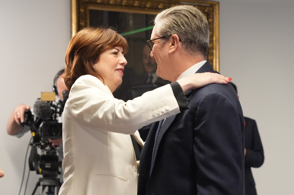 Woman placing her hand on a man's shoulder during the Labour deputy leadership contest.
