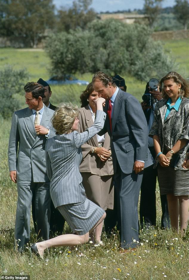 Princes Diana (pictured, left) curtseys to King Juan Carlos of Spain, who kisses her hand, as she and Prince Charles (left) leave Toledo after an official visit to Spain, April 25 1987