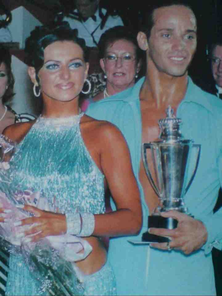Shirley Ballas with Michael Wentink holding a trophy and flowers.