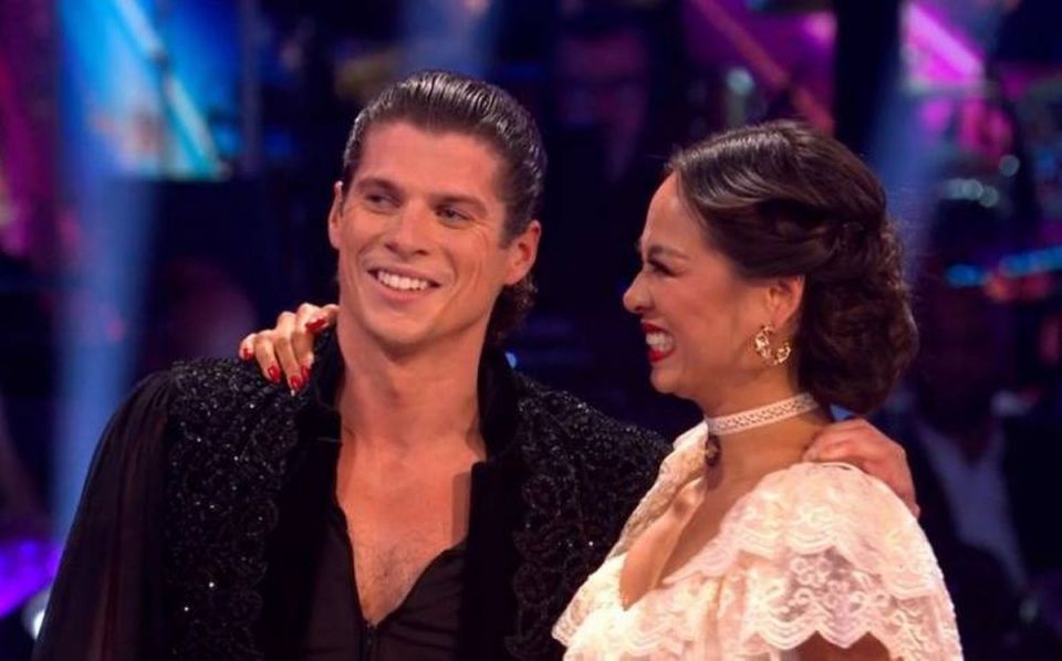 Lewis Cope smiling with his arm around his dance partner.