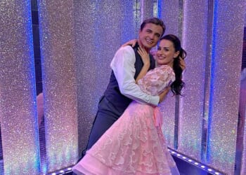 Strictly professional Nikita Kuzmin and his celebrity partner Amber Davies have 'sizzling chemistry' after he was spotted kissing her head in the street