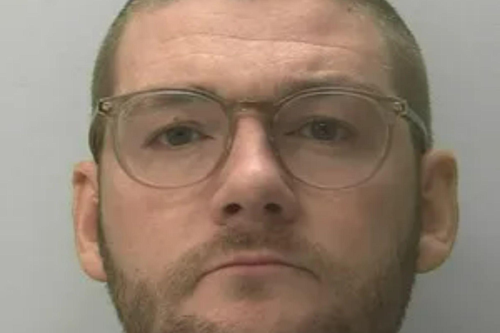 An image collage containing 1 images, Image 1 shows Mugshot of Ricky Stubberfield, a man with glasses, a beard, and short hair, facing forward