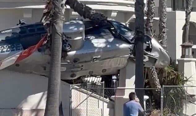 Video footage from Huntington Beach, California, shows the terrifying moment a helicopter spiraled out of control and crashed into a beachfront hotel on Saturday
