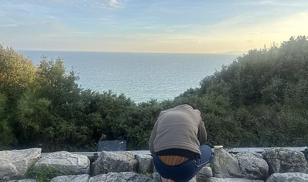 'Take me home': Jordanian asylum seeker Ahmad Hani (pictured overlooking the sea view) does not feel safe in Bournemouth and wants to return home