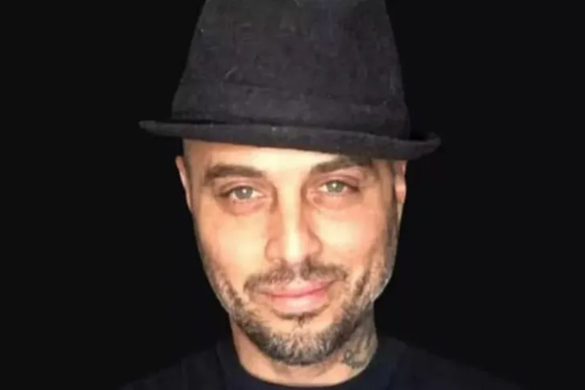 An image collage containing 1 images, Image 1 shows Headshot of RM Scott, a man with a beard and tattoos wearing a fedora