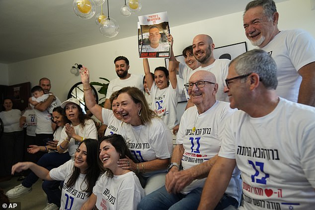 Family and friends of Bar Kupershtein celebrate as they await the release. Father Tal is pictured sitting second from right