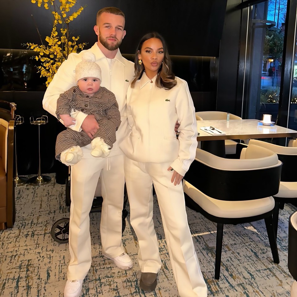 Chelsee Healey and family, all wearing matching white outfits, posing for a picture in a restaurant.