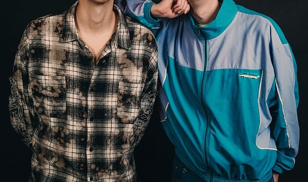 Leaning on one another, with huge smiles, Dan Howell and Phil Lester look like the perfect, happy couple