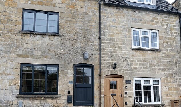 Pictured: One of the houses that has been installed with a black front door and black windows. The changes have not sat well with some residents who feel it is not in character with the area