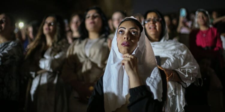 Egyptian Coptic Christians attend the Resurrection Mass at the Monastery of Saint Simon Al-Kharaz during Holy Saturday services on April 19 in Cairo, Egypt.