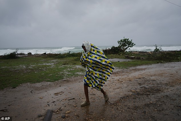 Residents in Cuba were pictured braving the wild winds ahead of the storm making landfall
