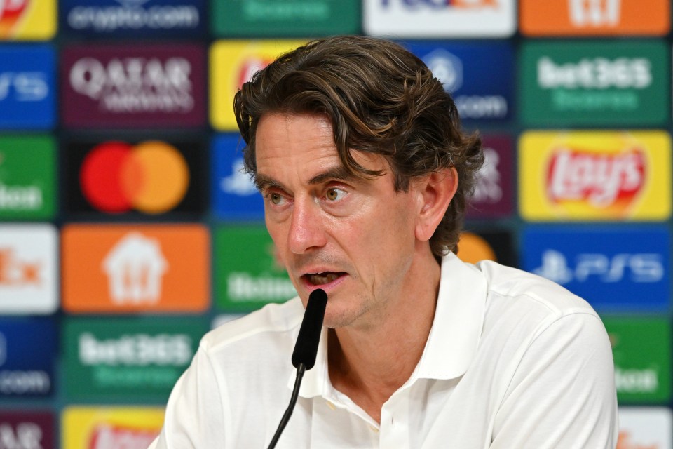Tottenham Hotspur Manager Thomas Frank speaking into a microphone at a press conference.