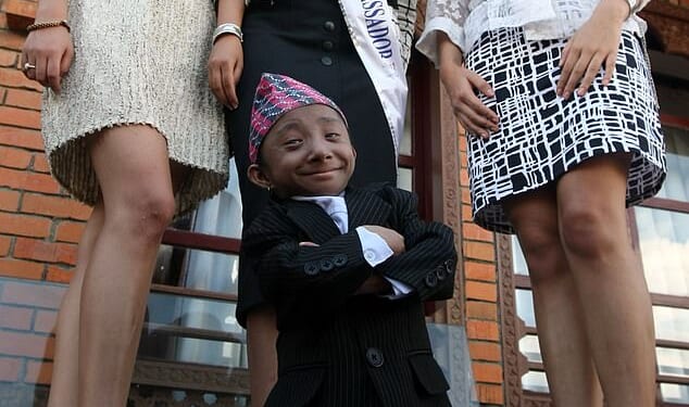 Khagendra Thapa Magar, from Nepal, stood just 2ft 2.4 inches tall when he was officially crowned the world's shortest man by Guinness World Records in 2010. Pictured: Khagendra Thapa Magar poses for a picture with Miss Nepal Sadichha Shrestha (C) and first runner-up Sahana Bajracharya (R) and second runner-up Samyukta Timilsina (L) in Kathmandu