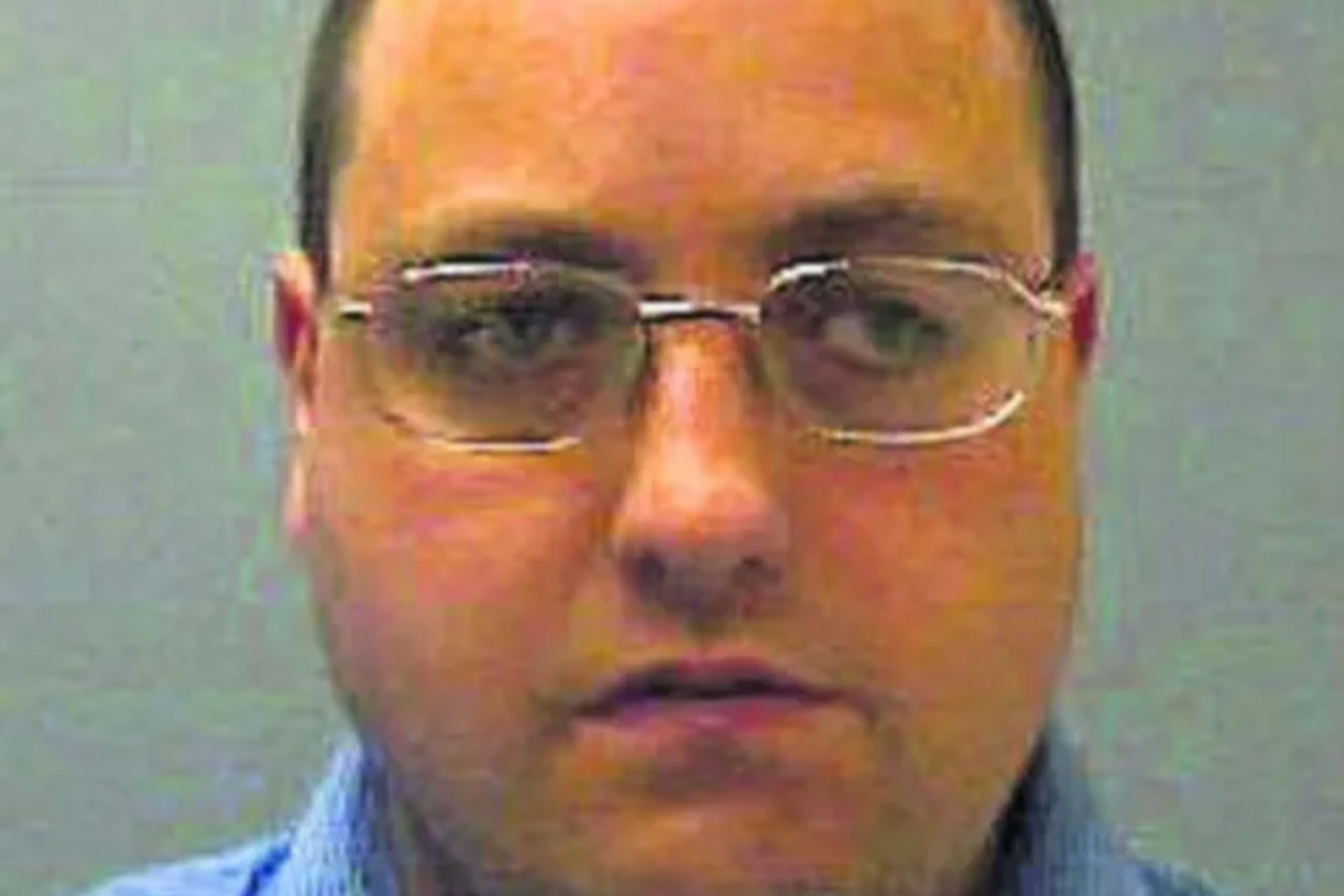 An image collage containing 1 images, Image 1 shows Mugshot of a light-skinned man with closely cropped dark hair and glasses, wearing a blue collared shirt