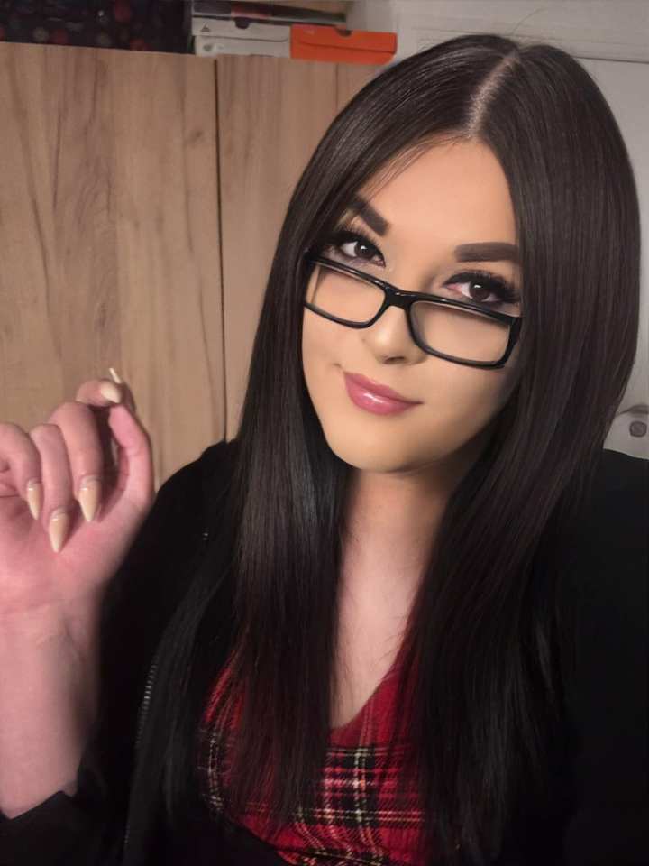 Victoria Barany, a woman with long dark hair and glasses, posing for a picture.