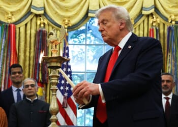 President Donald Trump lights a diya candle during an event celebrating Diwali in the Oval Office of the White House in Washington, D.C., on Tuesday.