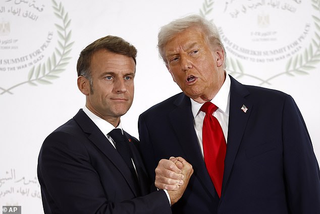 Donald Trump and Emmanuel Macron continued their ongoing handshake contest with a bizarre 'arm-wrestle' as they greeted each other at Monday's peace summit