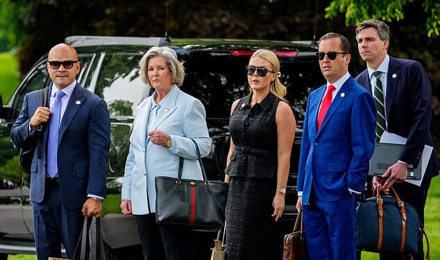 From left: Aide Walt Nauta, White House Chief of Staff Susie Wiles, White House press secretary Karoline Leavitt, Assistant to the President Sergio Gor, and an aide, wait for U.S. President Donald Trump to board Marine One on the South Lawn before joining him on May 1