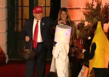 President Donald Trump has brought Halloween joy to children by handing out candy at the White House, rehashing a party trick from 2019 by patting a child's head with a bar of chocolate