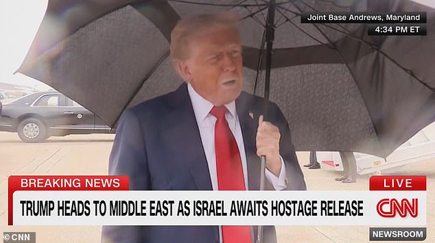 Trump addressed reporters just before he boarded Air Force One as he stood beneath an umbrella that shook in the powerful wind