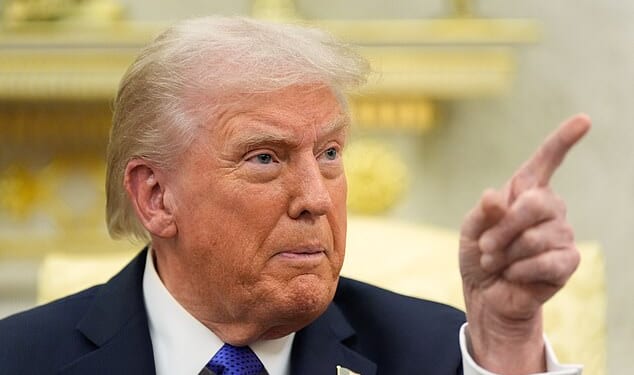 President Donald Trump points as he answers questions from reporters at the White House