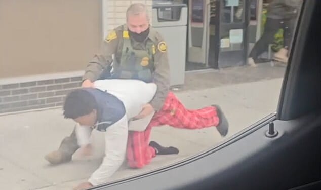 In a horrifying clip, a masked ICE officer slammed a black teenager into the ground for running despite his relative telling them he is an American citizen