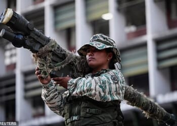 A member of the Bolivarian Militia holds a weapon during a rally amid rising tensions with the United States, in Caracas, Venezuela, on Thursday
