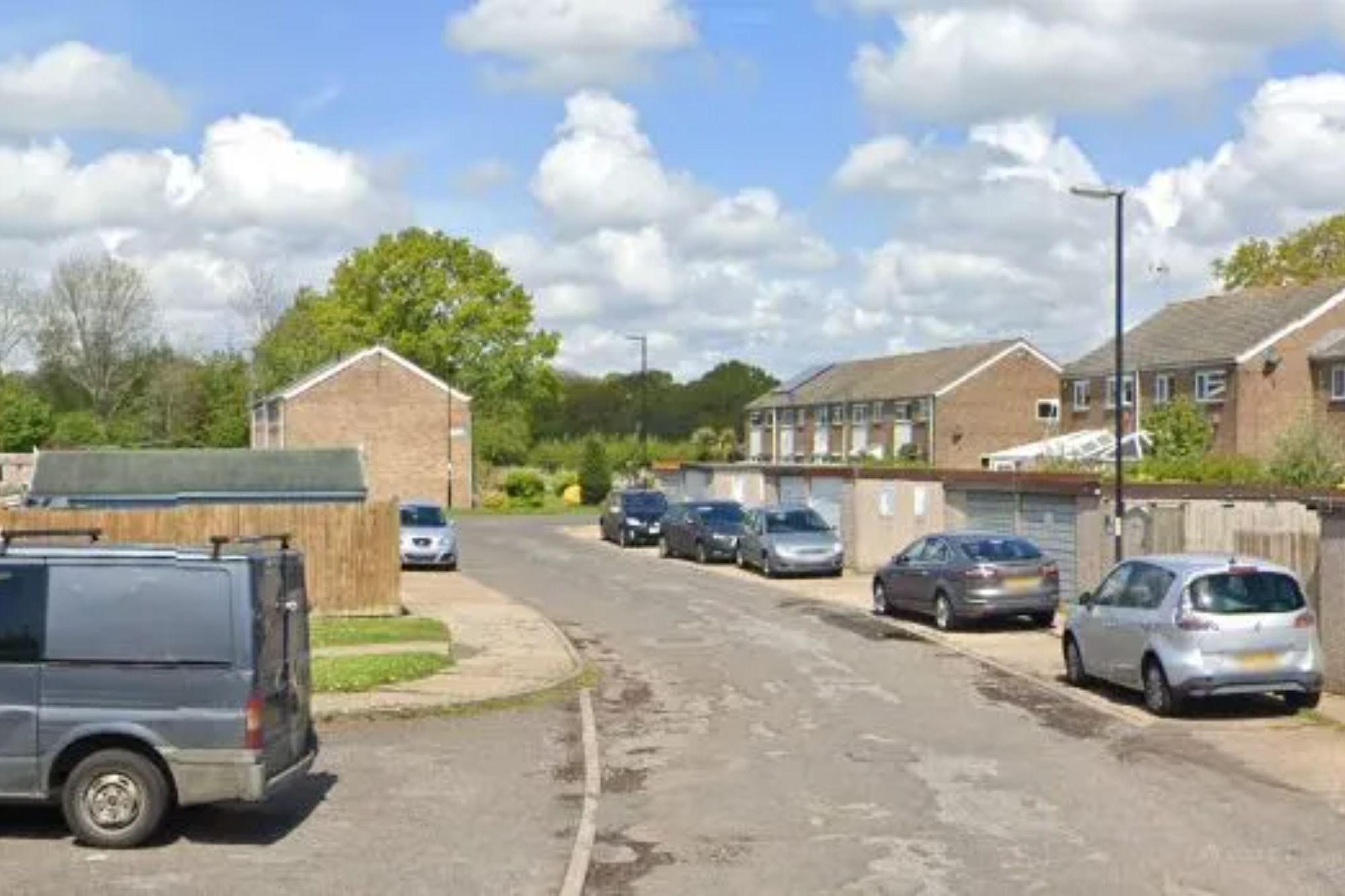 An image collage containing 1 images, Image 1 shows Residential street with parked cars and garages lining the road