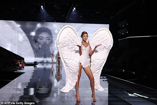 The outfit was framed by plump white pillow-like wings