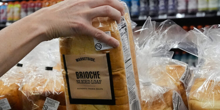 A customer reaches for a loaf of Marketside brand bread at a Walmart Neighborhood Market in Bentonville, Arkansas, on Friday.