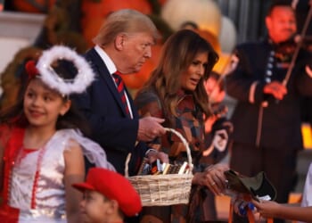 President Donald Trump and First Lady Melania Trump hand out candy to children as they trick-or-treat during a Halloween at the White House event at the South Portico of the White House on Oct. 28, 2019, in Washington, D.C.