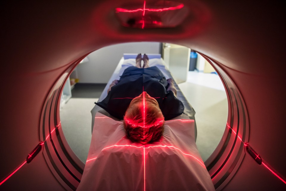 Person undergoing a CAT scan in a hospital.