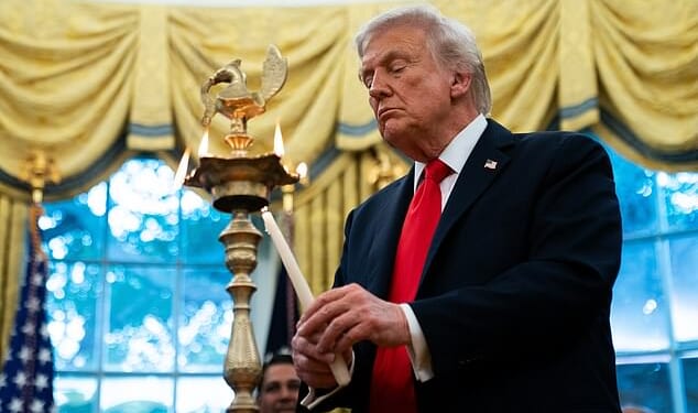 Donald Trump lights a diya candle during a Diwali celebration in the Oval Office of the White House on Tuesday