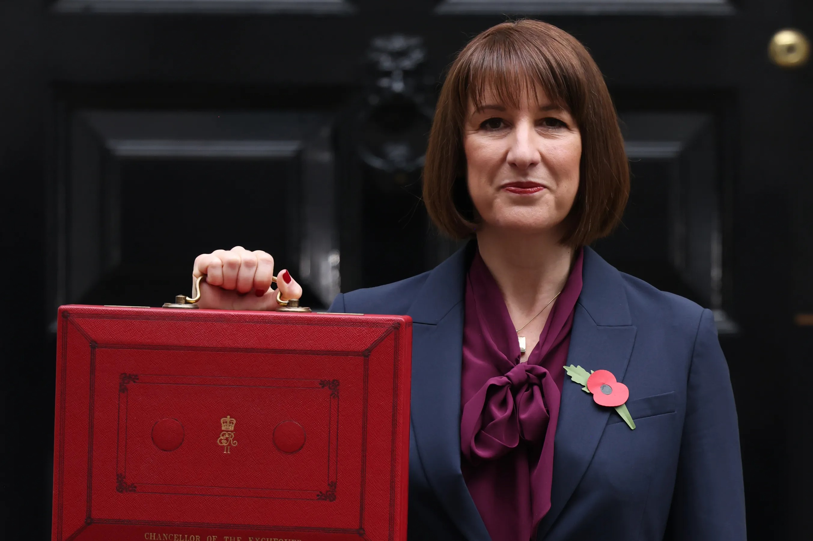 Rachel Reeves, UK Chancellor of the Exchequer, outside 11 Downing Street, holding a red budget box.
