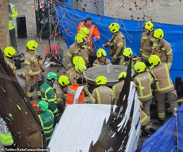 FIrecrews are seen trying to lift the pop up urinal after it fell on Mr Holding in January 2023