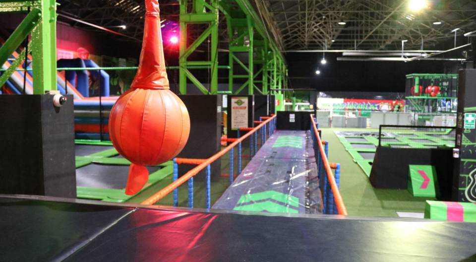 The "World's biggest trampoline park - Flip Out" showing multiple trampolines and an orange punching bag.