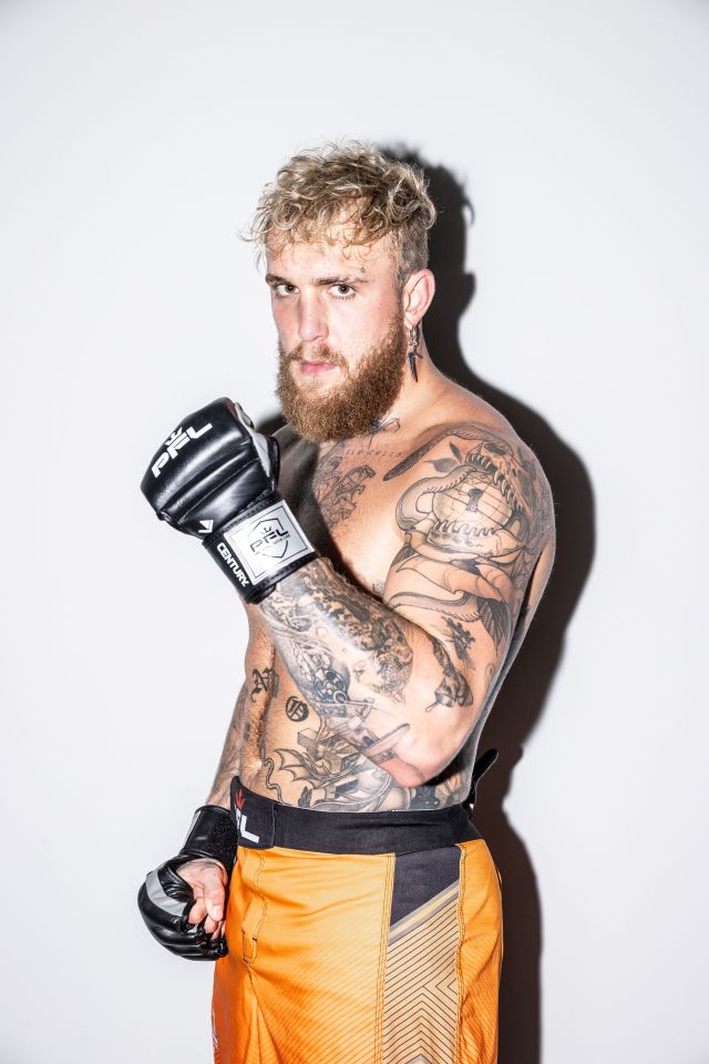Professional Fighters League fighter Jake Paul wearing PFL gloves and orange shorts.
