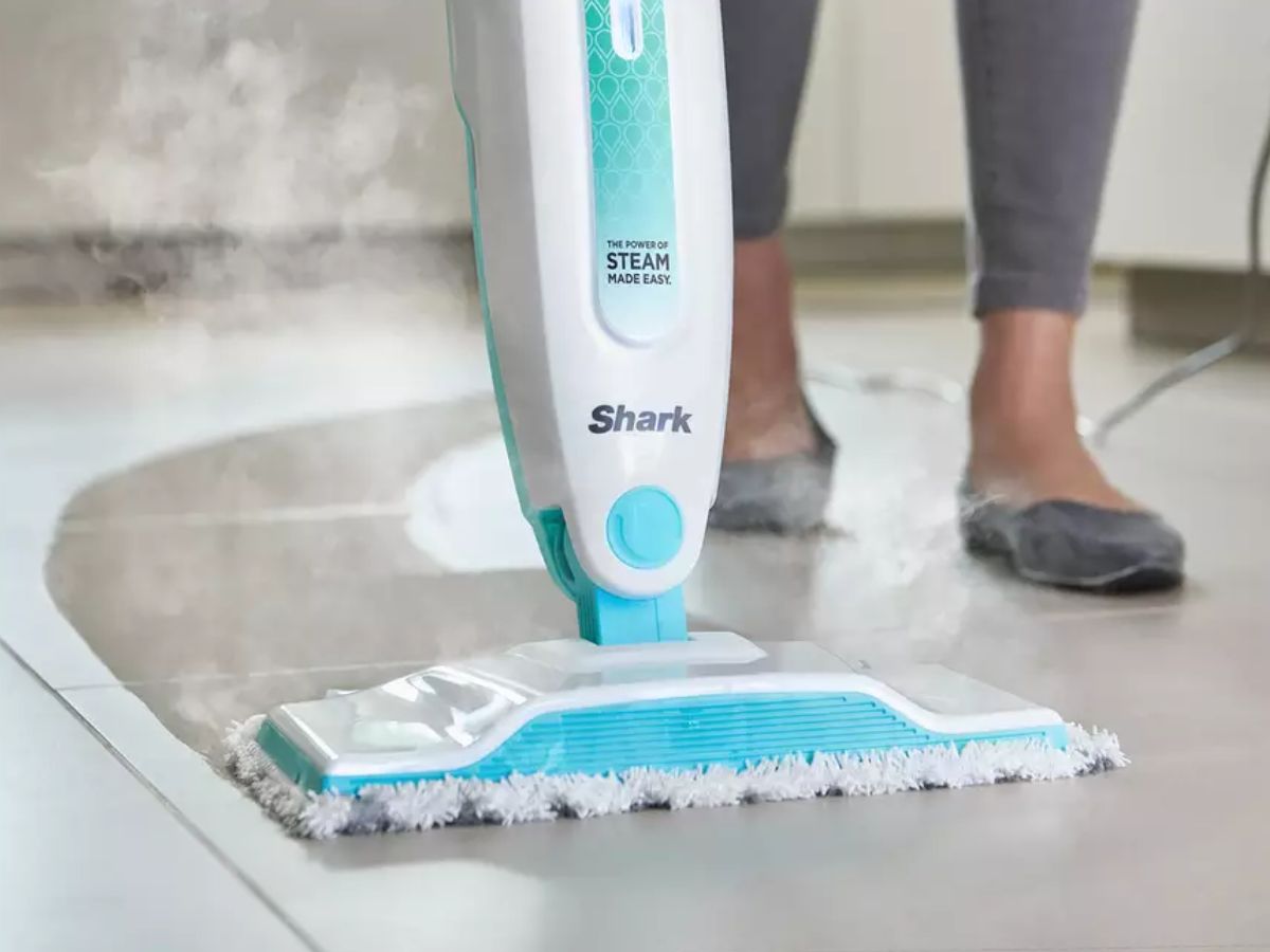 Shark steam mop cleaning a tiled floor.