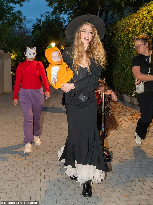 Heard was clad in a clinging black witch dress with black boots and a pointed hat