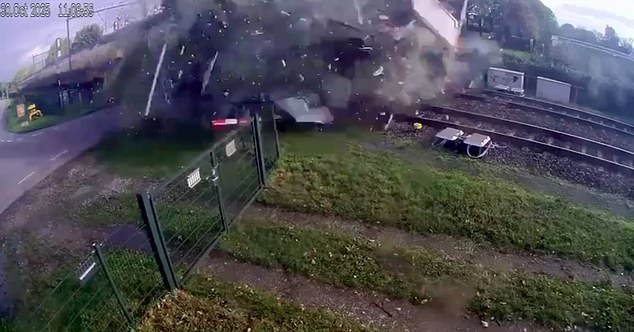 Thousands of bits of debris go flying after the train hurtles straight through the fruit-bearing lorry